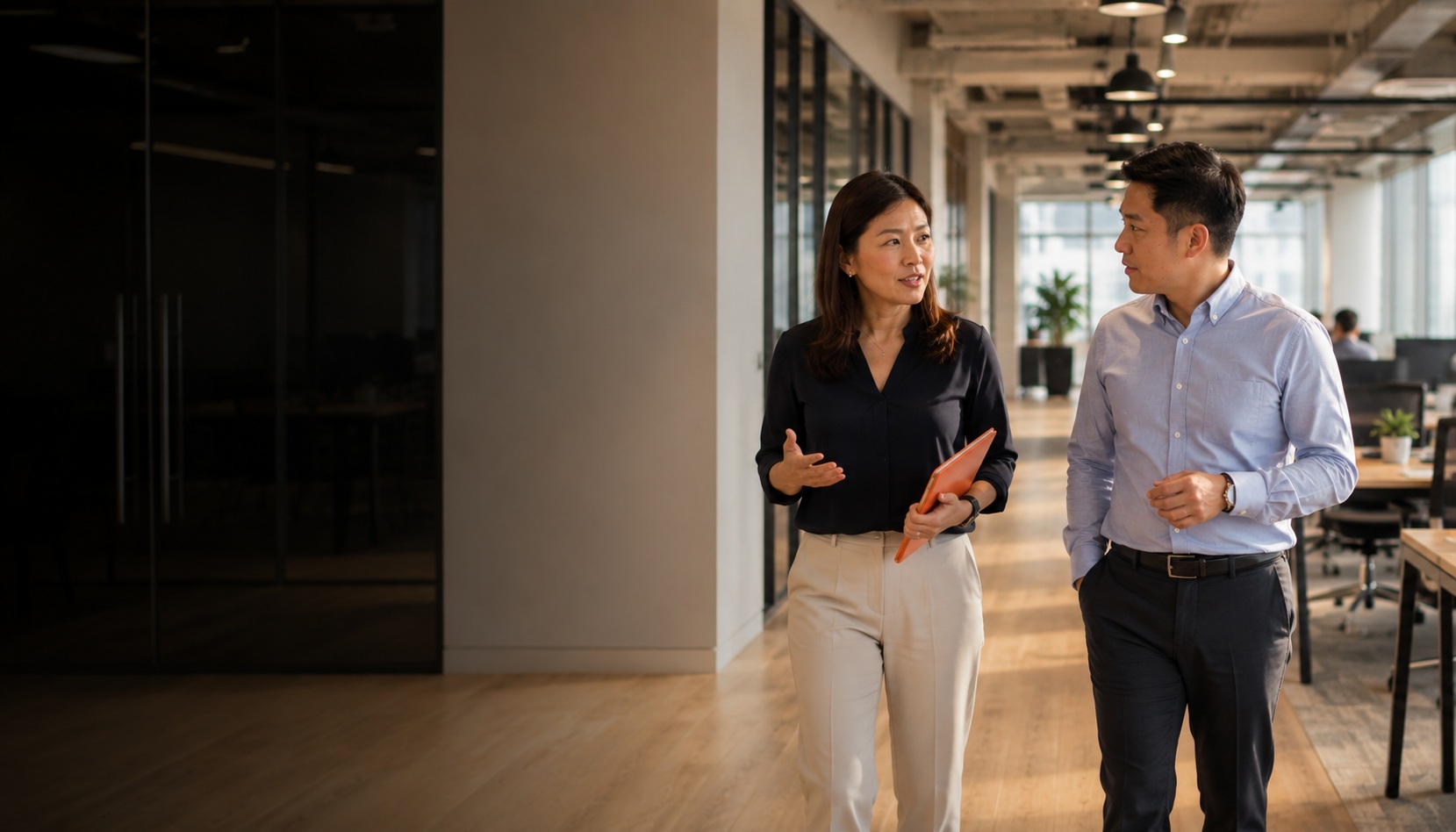 HR Shared Services Singapore - People Profilers HR consultant walking with client through a Singapore office, mid-conversation about HR services